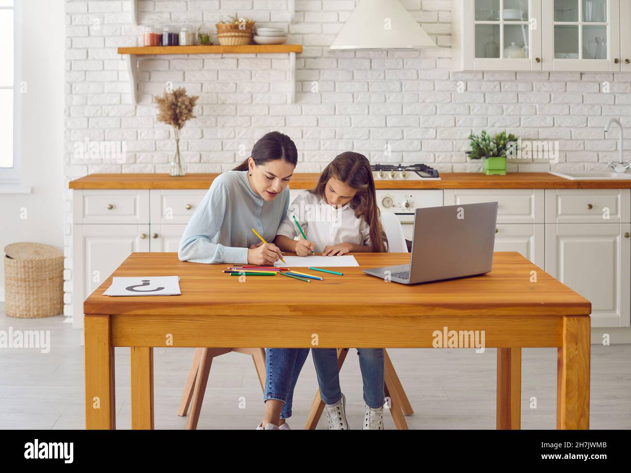 Professional female psychologist talks and draws with teenage girl during session. Stock Photo