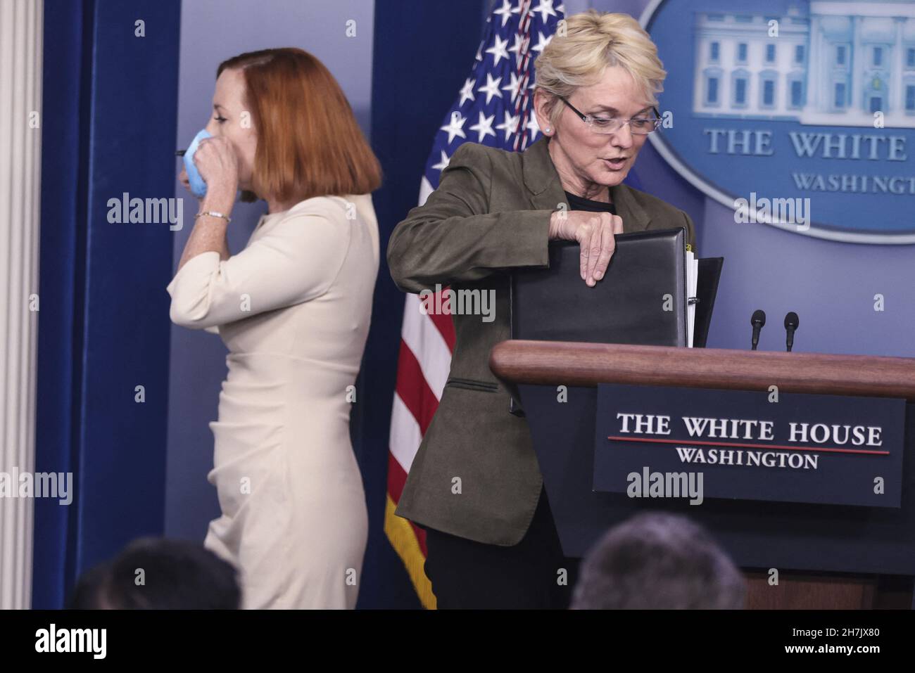 Jen Psaki, White House press secretary, left, walks out of the podium next  to Jennifer Granholm, U.S. energy secretary, speaks during a news  conference in the James S. Brady Press Briefing Room