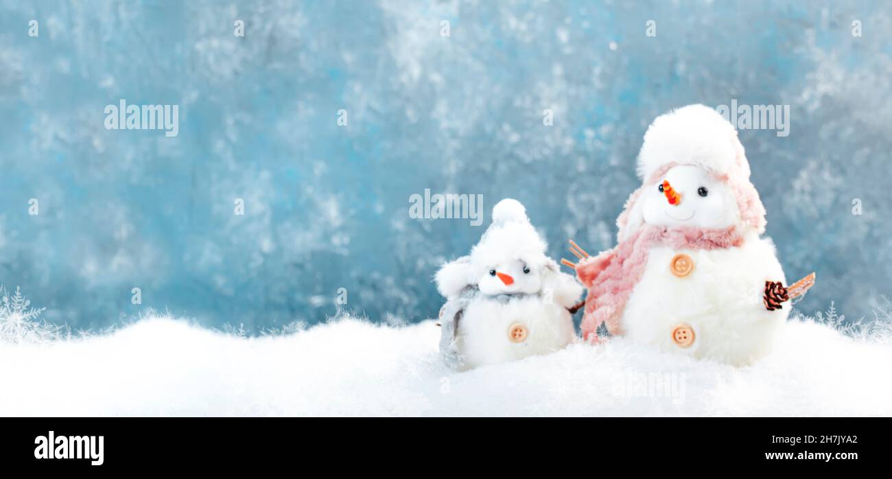 Christmas and new year snow concept with two cute snowmen in hats and ...