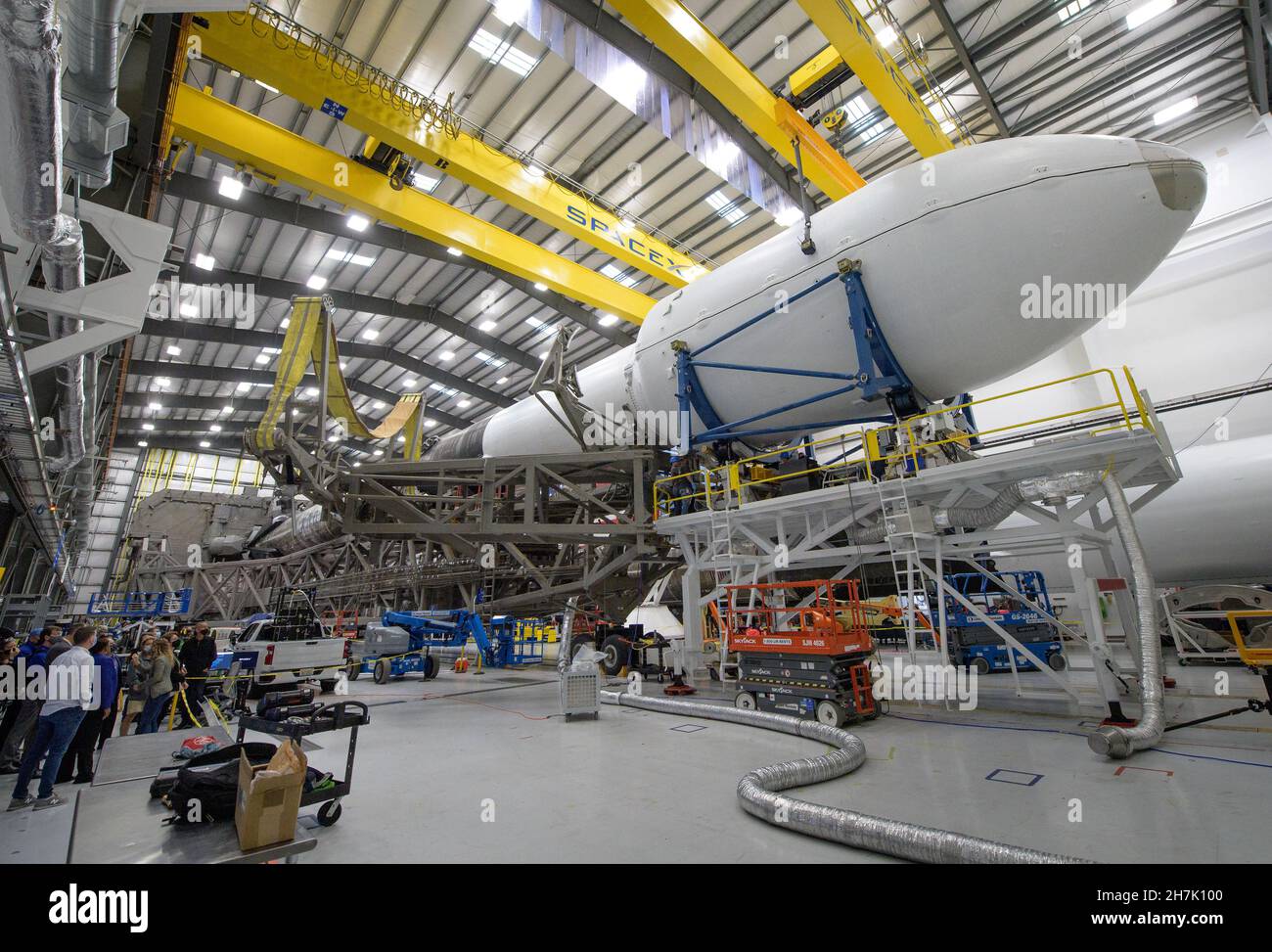 The Falcon 9 rocket and DART spacecraft readied for launch are seen as NASA Associate Administrator for the Science Mission Directorate Thomas Zurbuchen, and other NASA leadership get a tour from Julianna Scheiman, director for civil satellite missions, SpaceX, Monday, Nov. 22, 2021, at the SpaceX hanger, Vandenberg Space Force Base in California. DART is the world's first full-scale planetary defense test, demonstrating one method of asteroid deflection technology. The mission was built and is managed by the Johns Hopkins APL for NASA's Planetary Defense Coordination Office. Mandatory Credit: Stock Photo