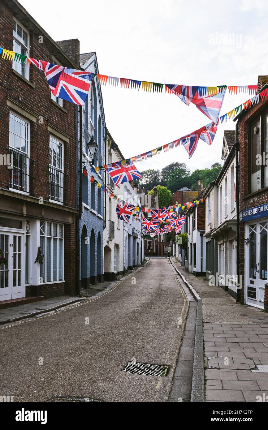 A street view of Courthouse Street decorated wtih bunting for the Jack In the Green festival, in Old Town, Hastings, East Sussex, UK. Stock Photo