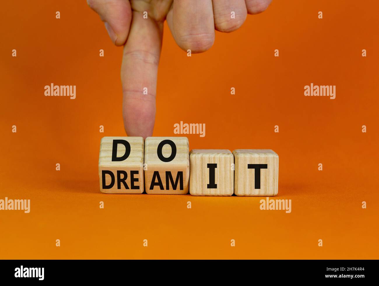 Dream and do it symbol. Businessman turns cubes and changes words ...
