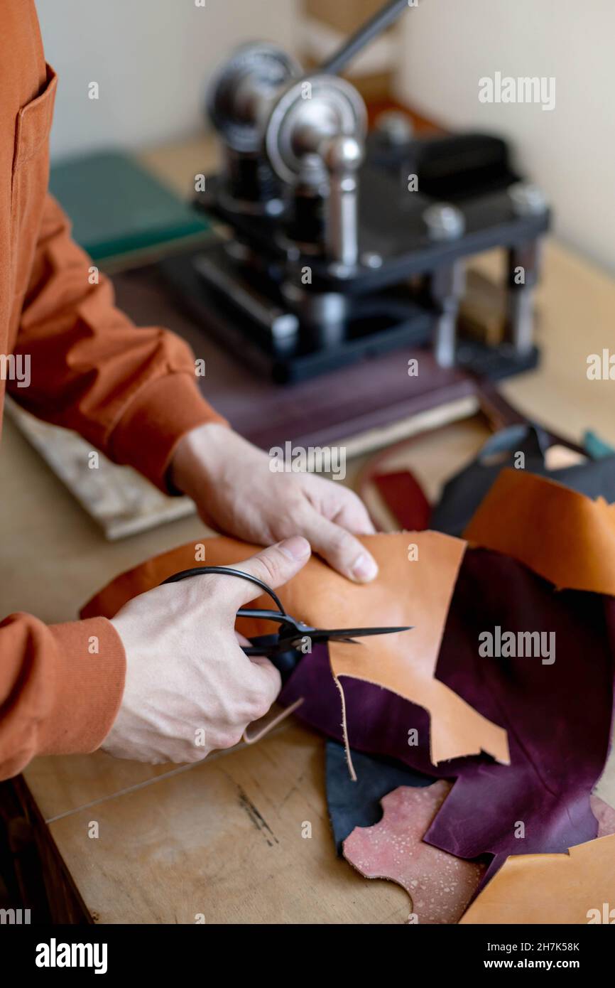 Craftsman cutting natural material use scissors. Working process at ...