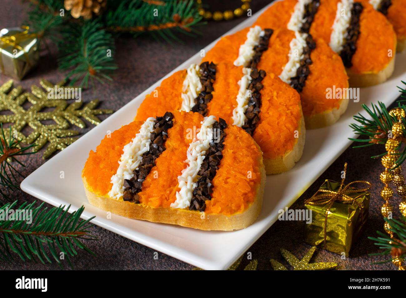 Christmas Sandwiches 2022 Tiger Sandwiches For New Year 2022 Of Carrot, Eggs And Black Olives On  White Bread On Plate On Brown Background Stock Photo - Alamy
