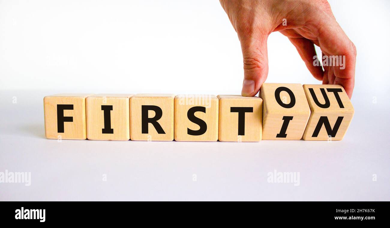 First in first out symbol. Businessman turns wooden cubes and changes ...