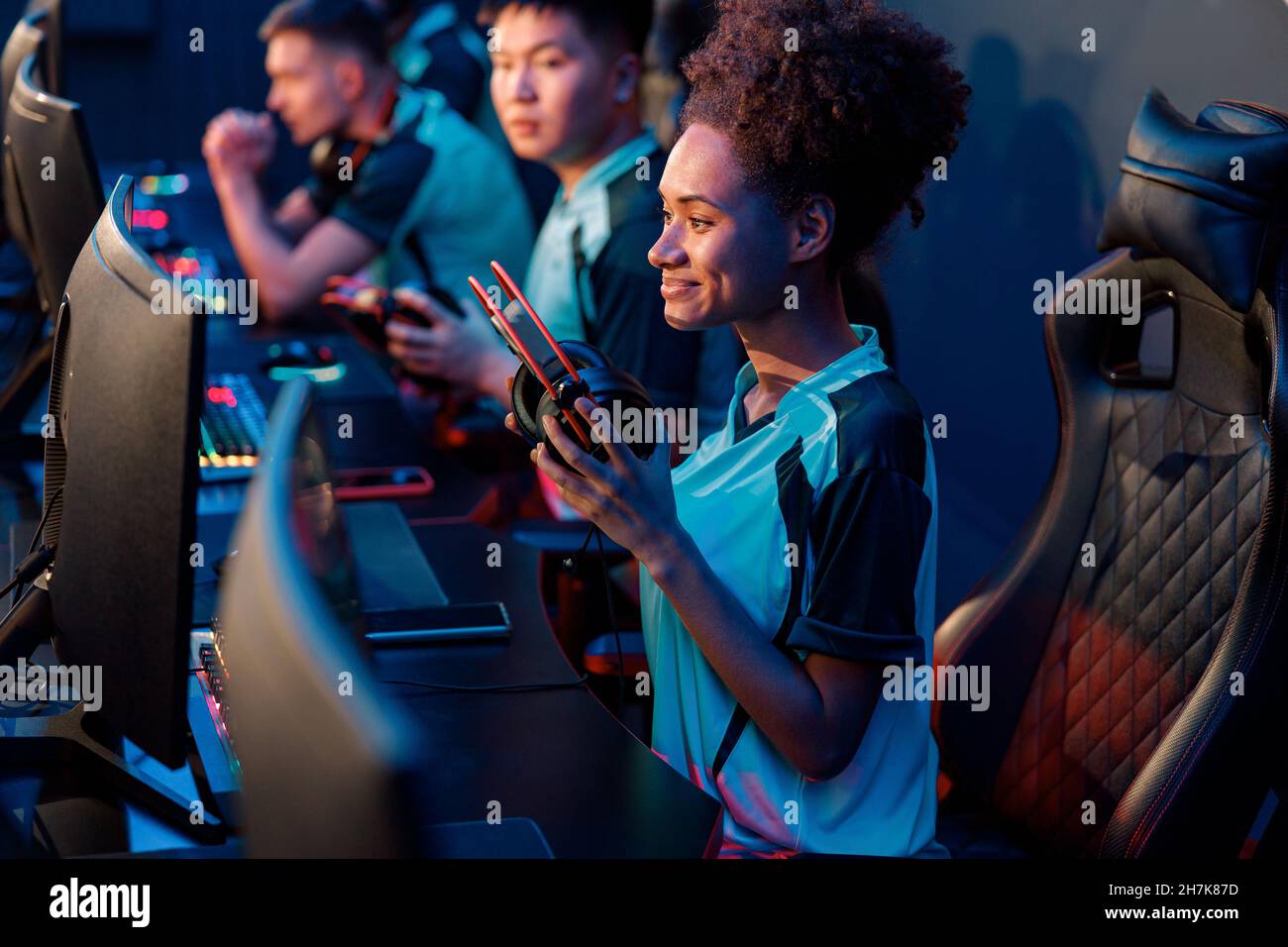 Competitive esports gamers playing online game in cyber club Stock Photo