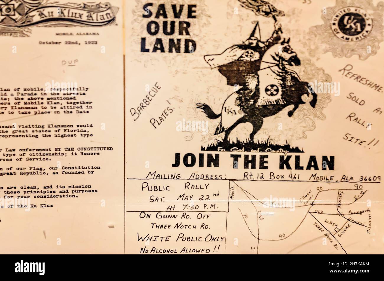 A poster for a Ku Klux Klan rally is displayed alongside a Klan parade permit request at the History Museum of Mobile in Mobile, Alabama. Stock Photo