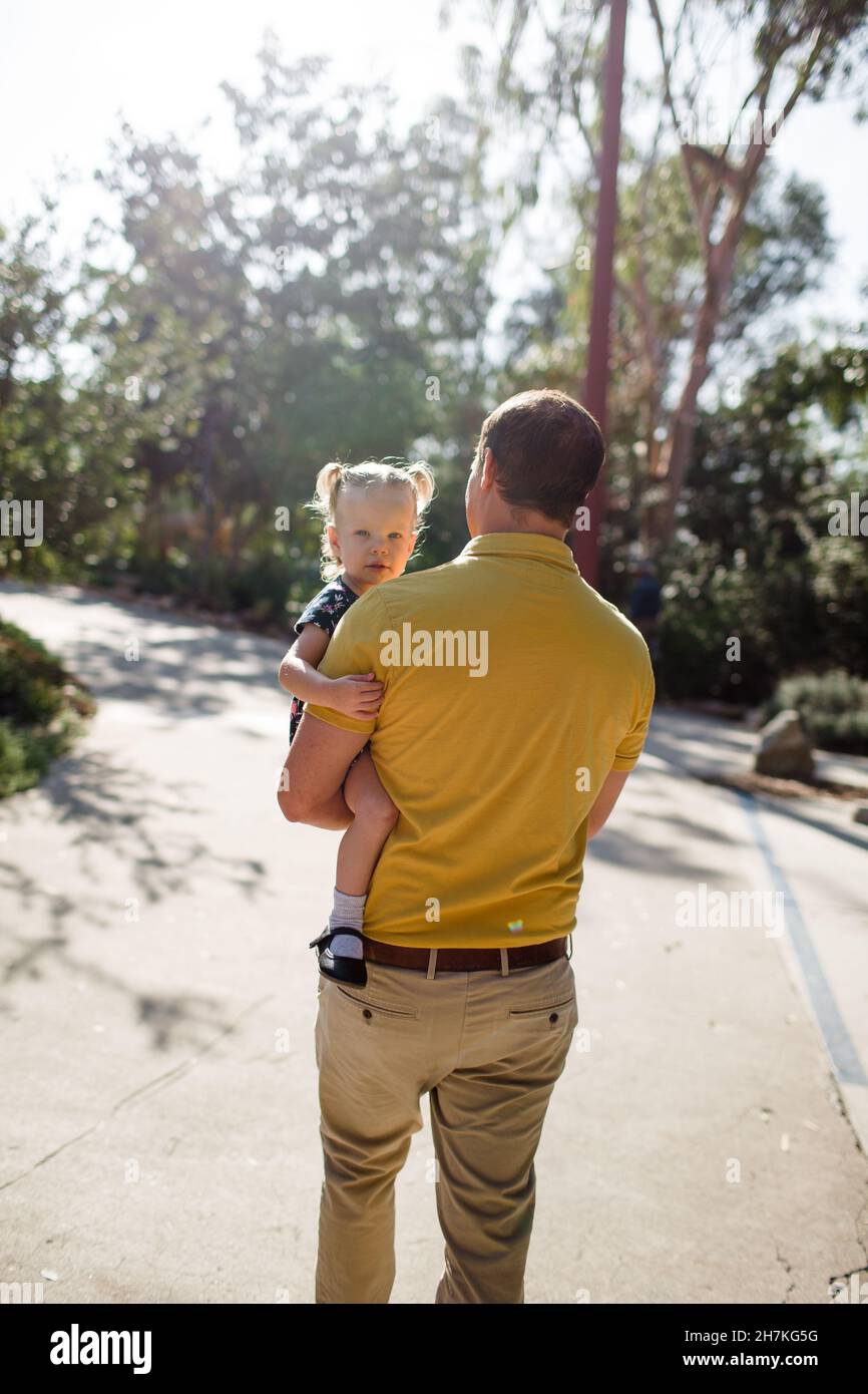 Dad Carrying Toddler Daughter in Garden in California Stock Photo Alamy