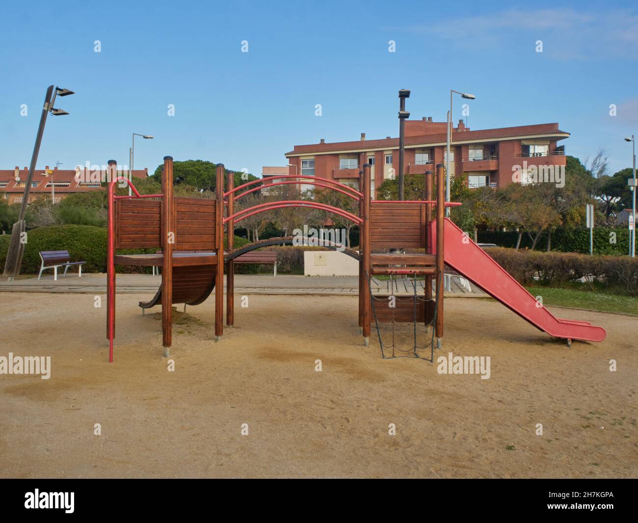 Empty Wooden children playground activities surrounded by green trees Stock Photo
