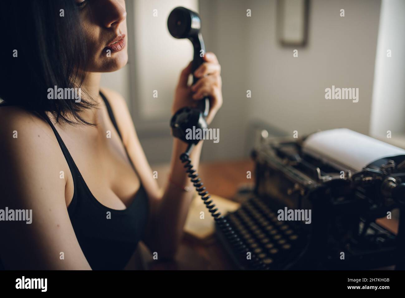 Woman making a phone call at home closeup. Stock Photo