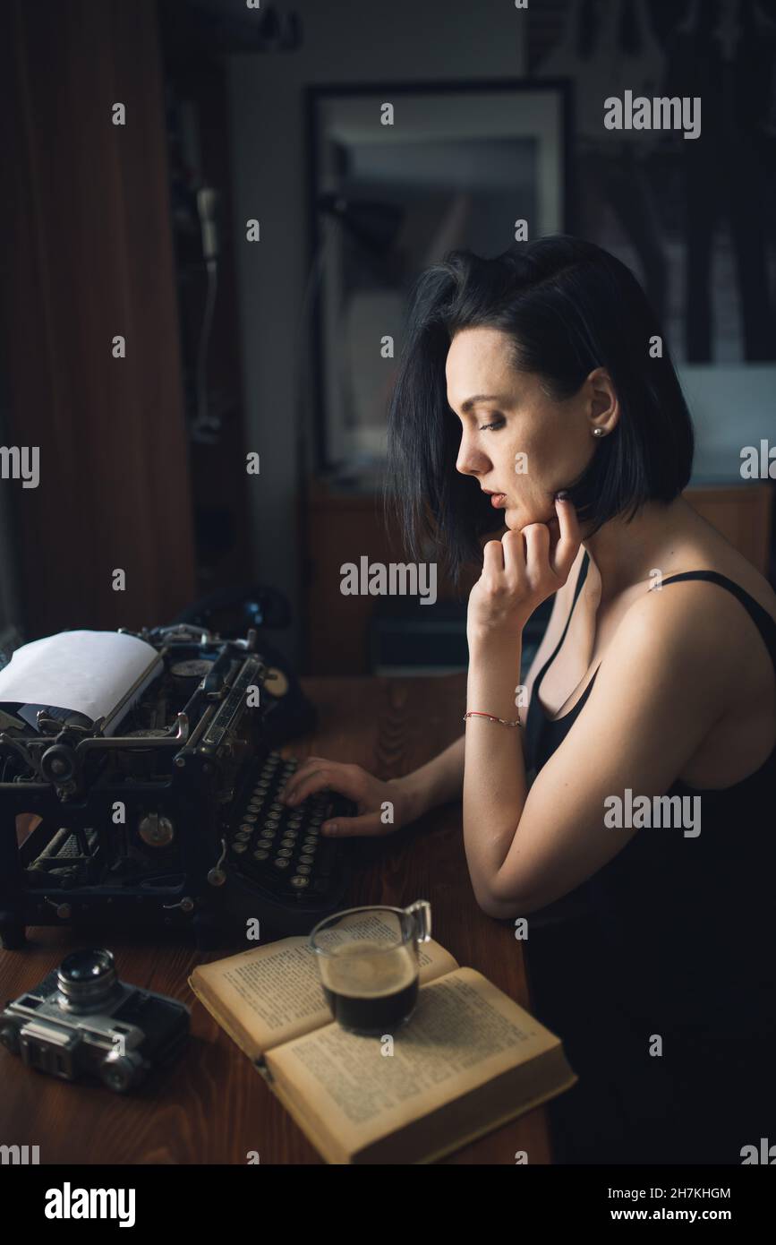 Young hipster woman talking on the phone at home. Stock Photo
