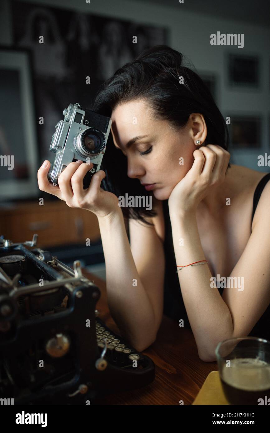 Tired woman with an analog camera. Stock Photo