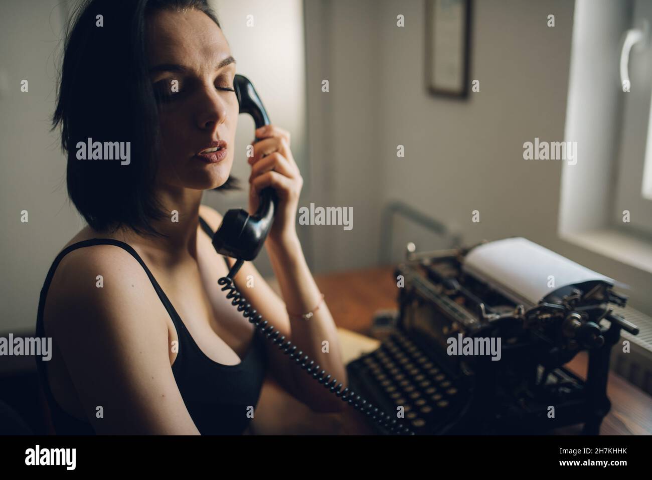 Lonely woman making a phone call at home closeup. Stock Photo