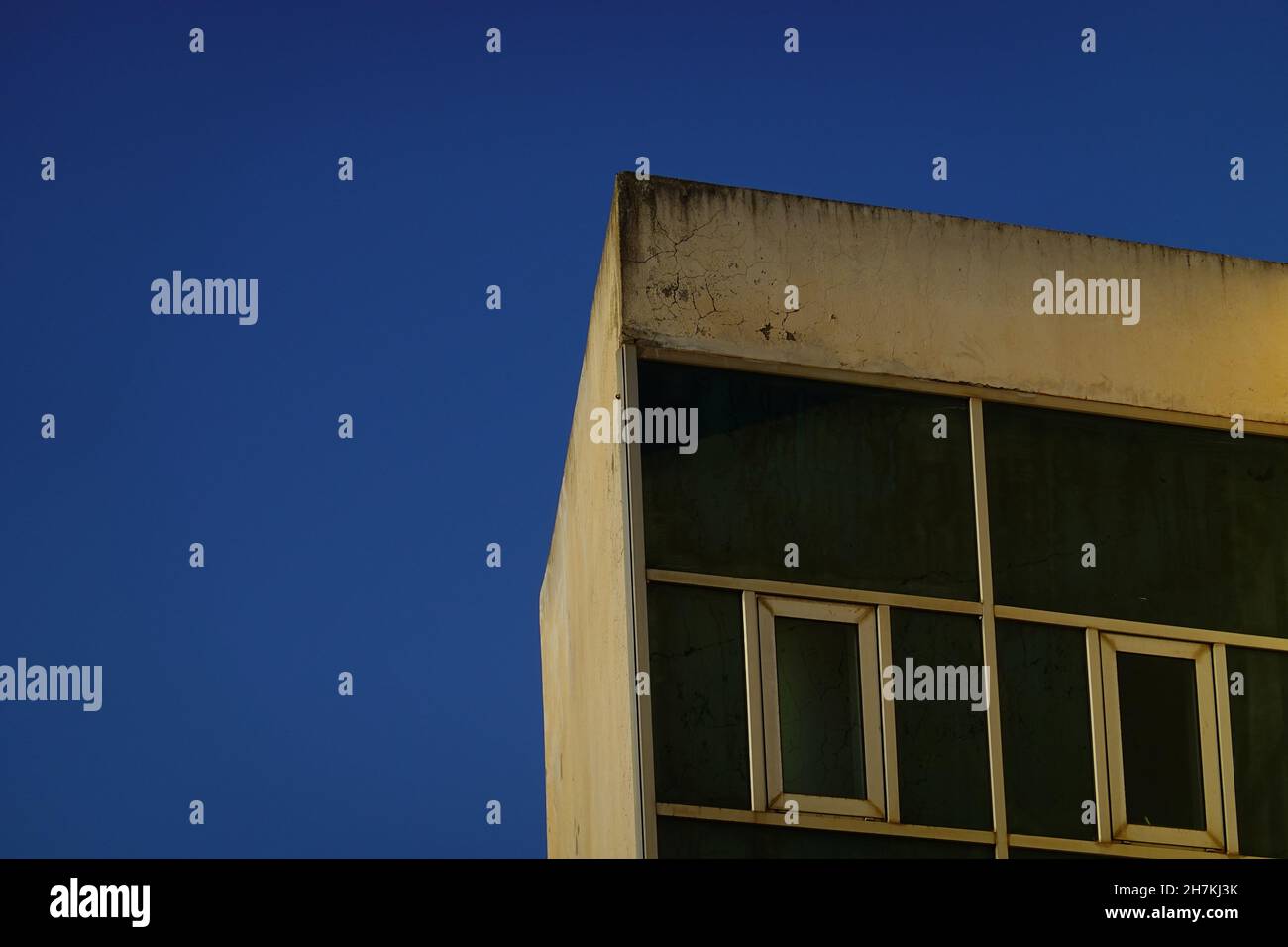 Low angle view of an old building facade under a blue sky Stock Photo ...