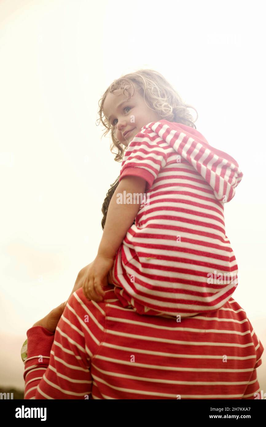Mother carrying daughter on shoulder Stock Photo Alamy
