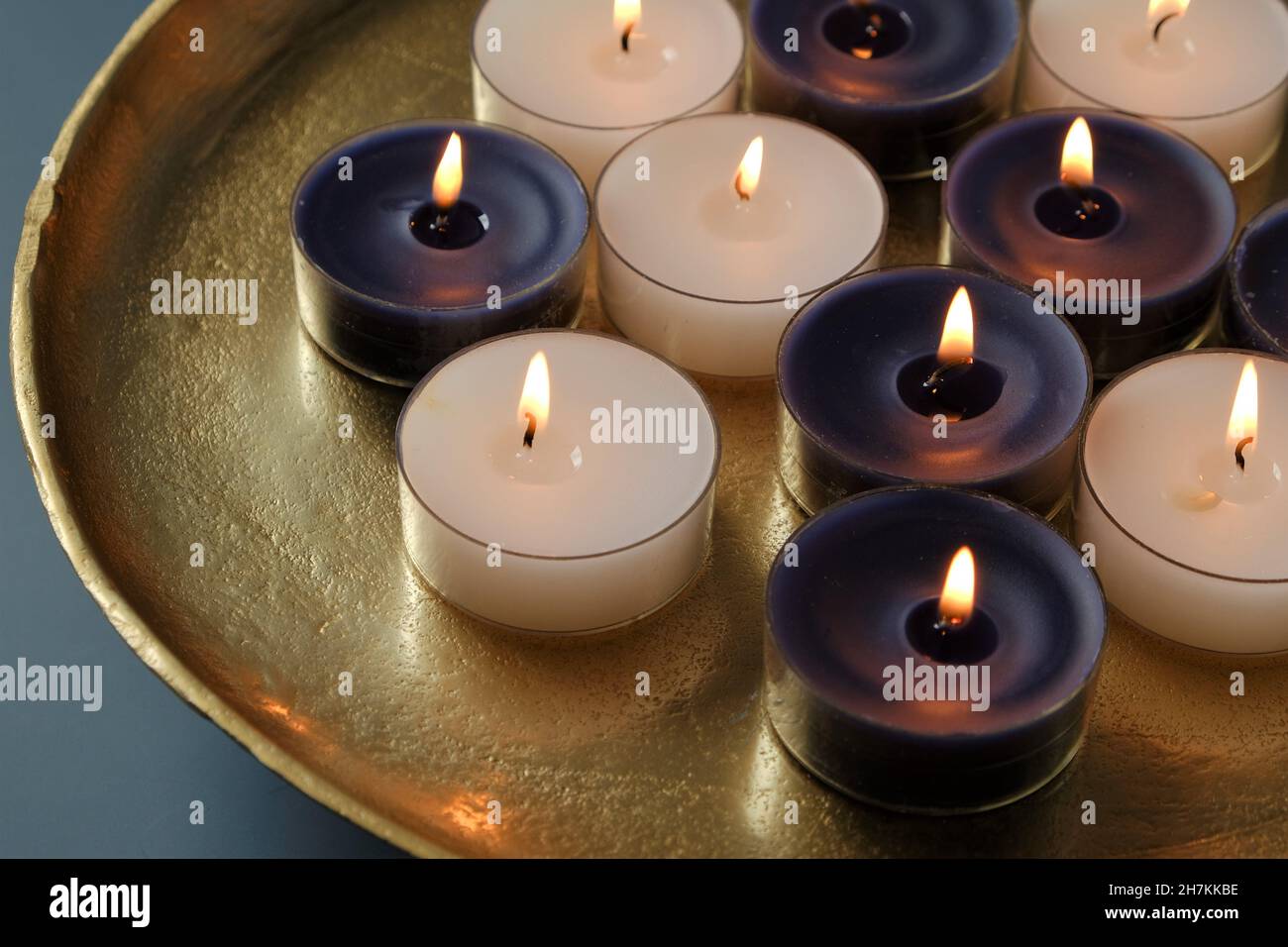 Candle flame. candles set in a gold tray on a dark blue background