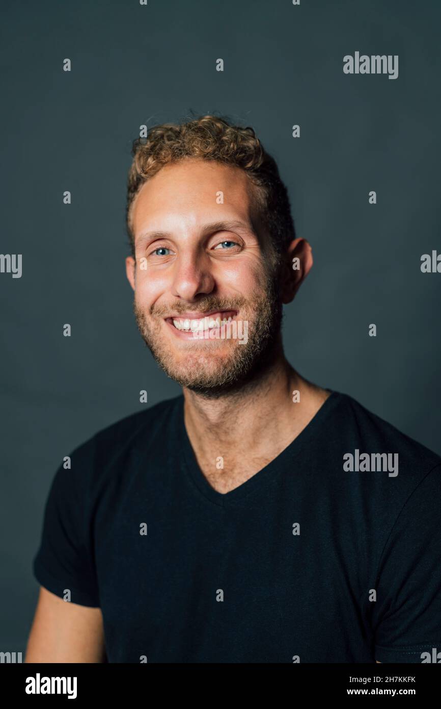 Happy young man against gray background Stock Photo