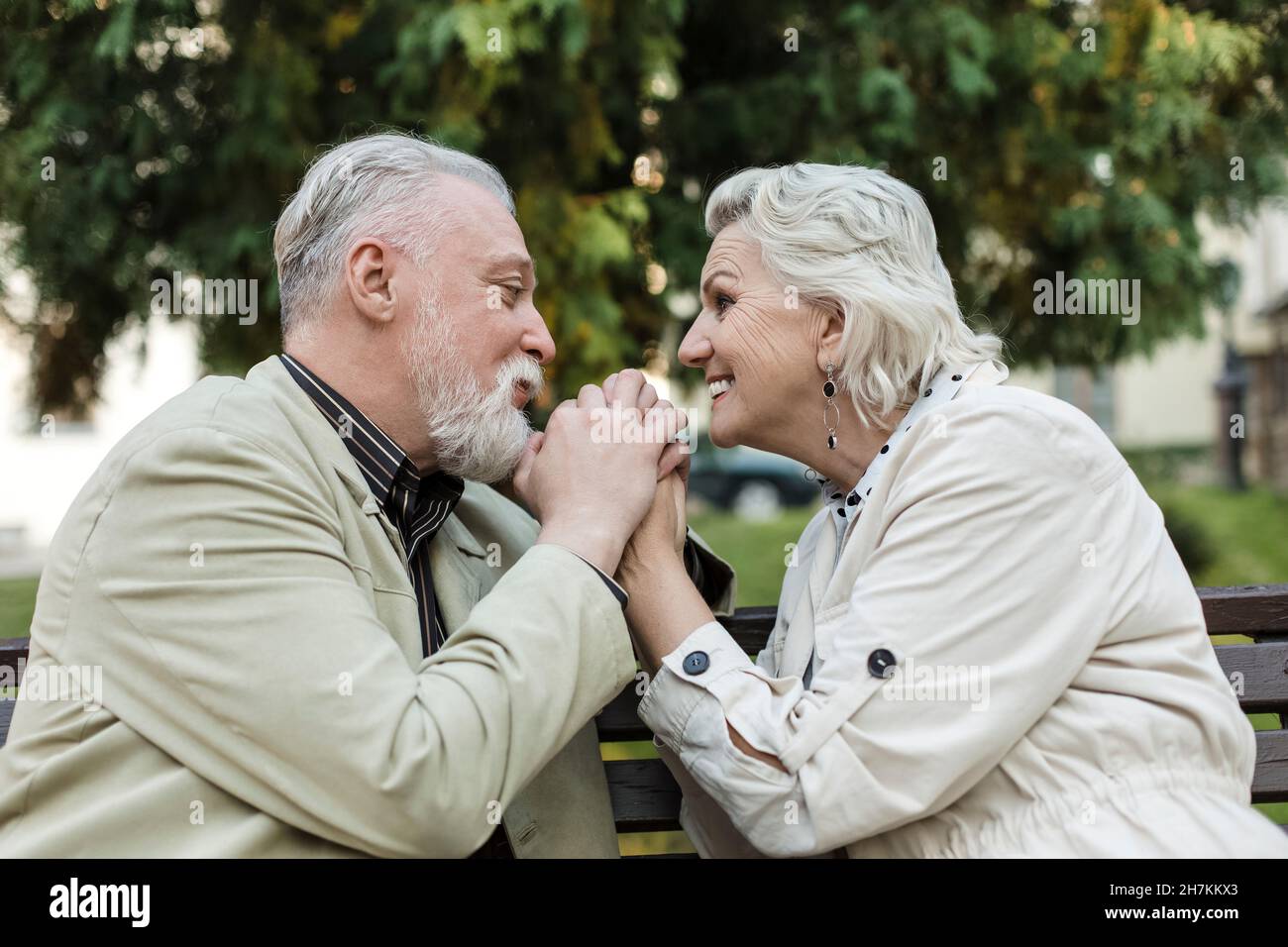Couple holding hands while looking at each other Stock Photo - Alamy