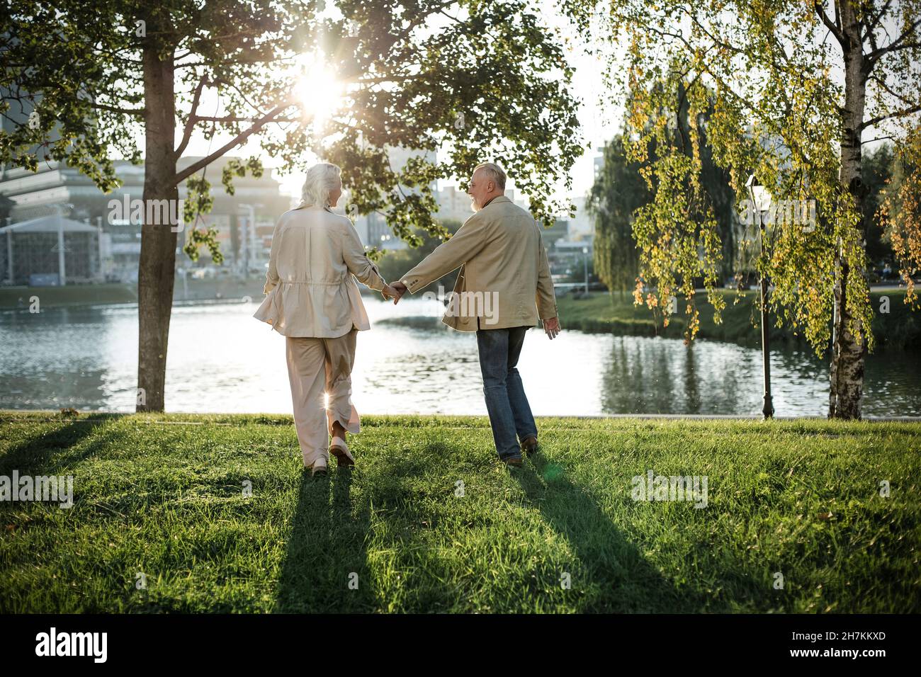 Rear view couple walking hand hi-res stock photography and images - Alamy