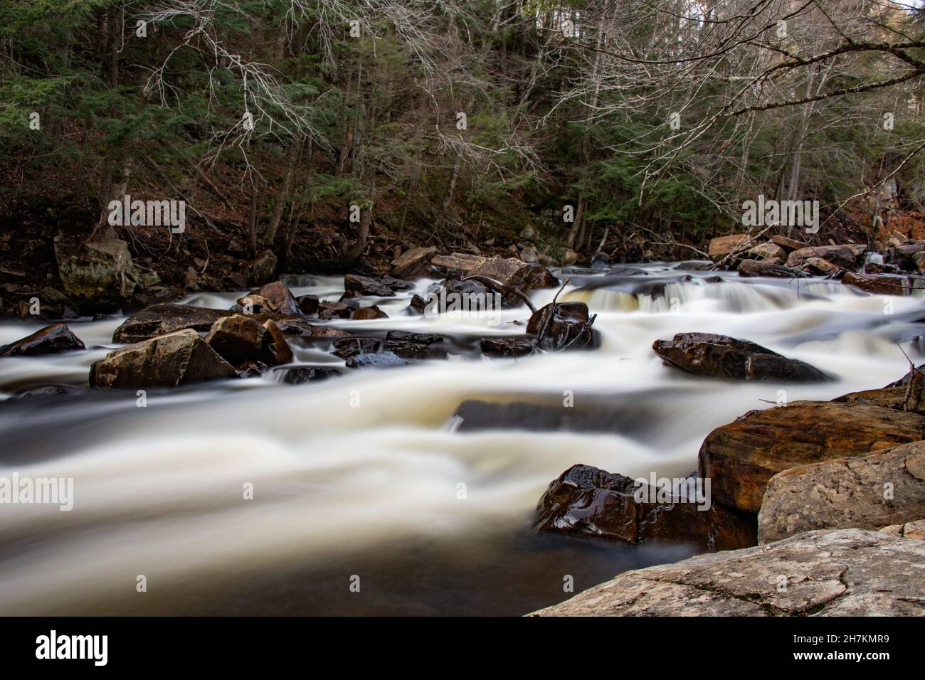A long exposure image of falls on the Sacandaga River in the Adirondack Mountains, NY USA in early winter. Stock Photo