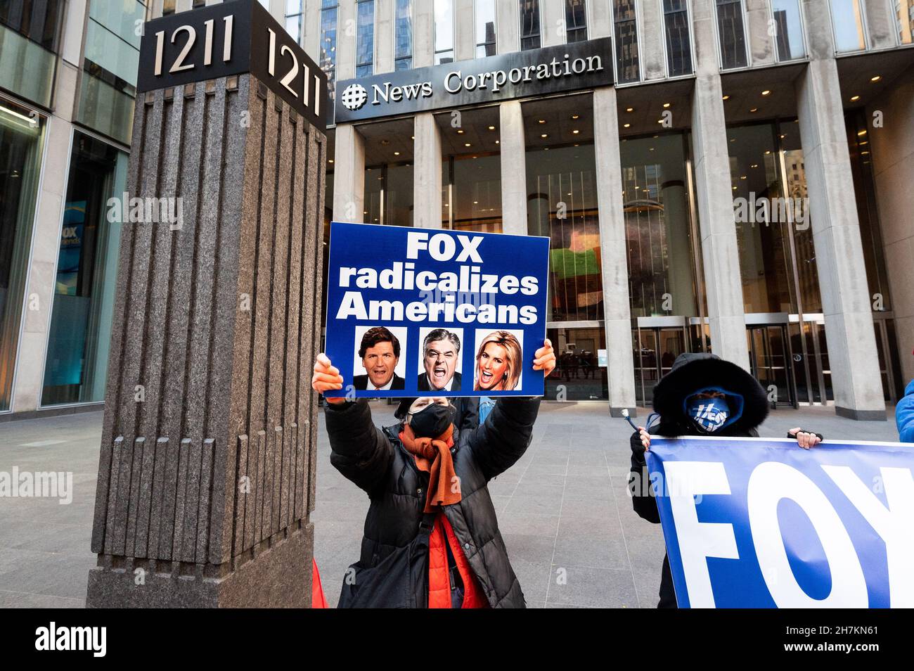 New York, United States. 23rd Nov, 2021. A woman with sign saying 'Fox radicalizes Americans' during a protest against Fox News outside its building on Sixth Avenue. Credit: SOPA Images Limited/Alamy Live News Stock Photo