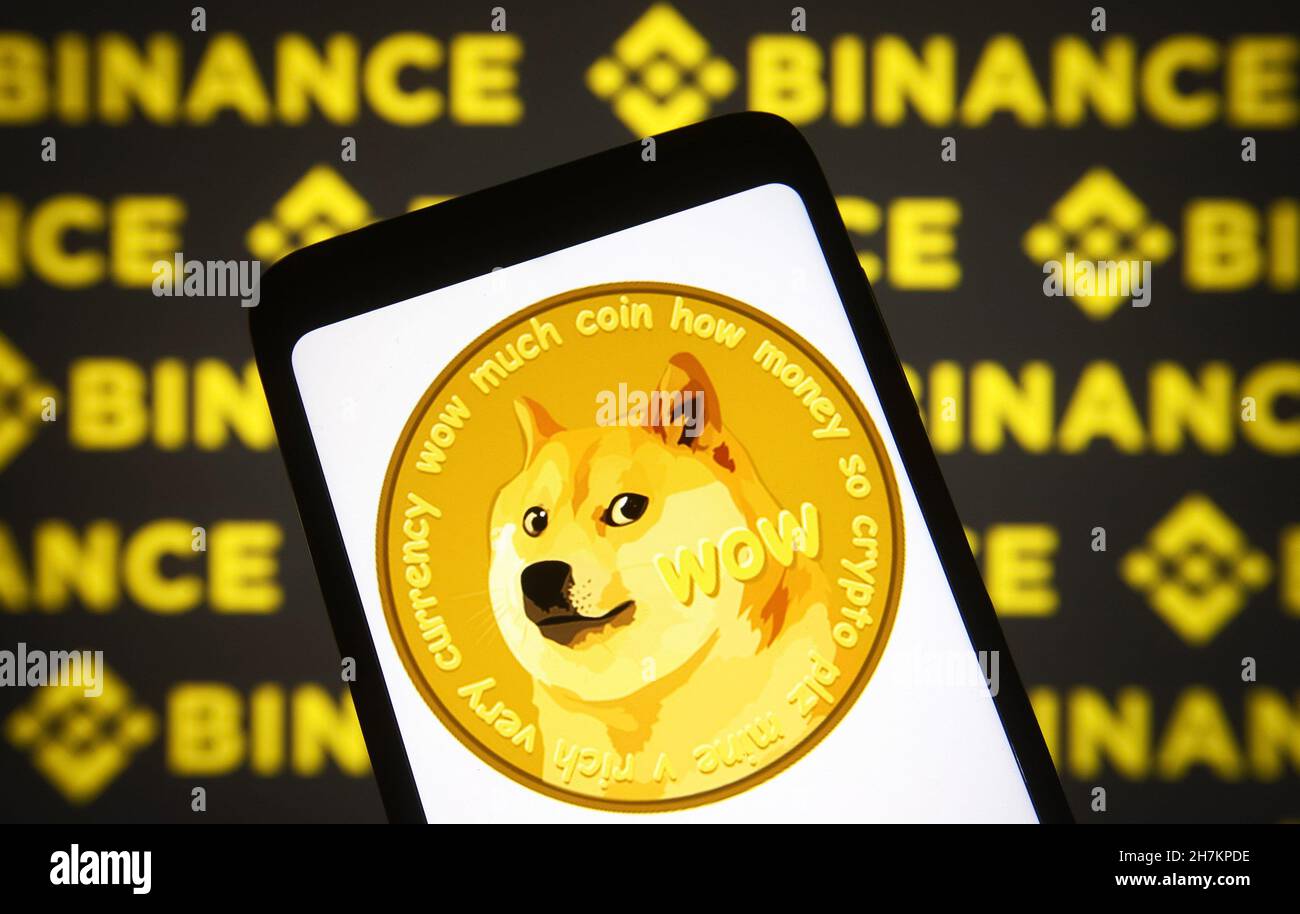Ukraine. 23rd Nov, 2021. In this photo illustration, a Dogecoin sign of a  cryptocurrency is seen on a smartphone screen with a Binance logo of a  cryptocurrency exchange in the background. (Photo