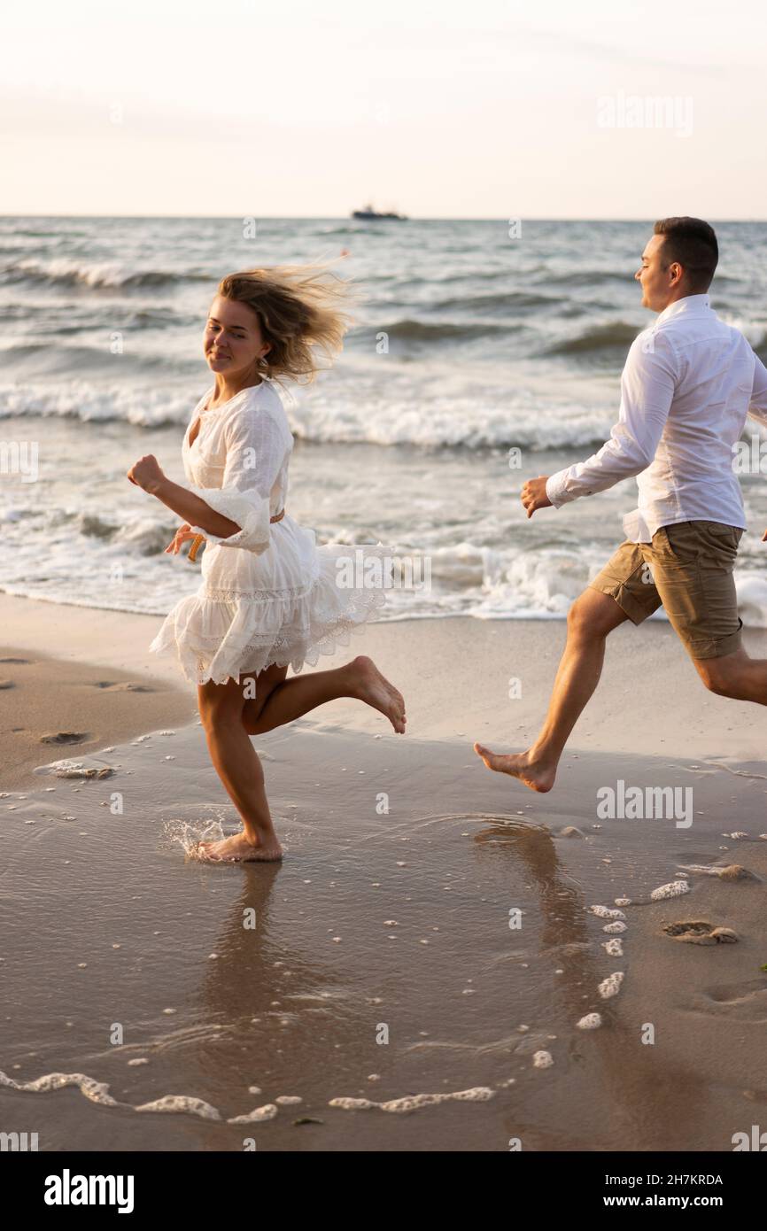 Girlfriend and boyfriend running at beach by sea Stock Photo
