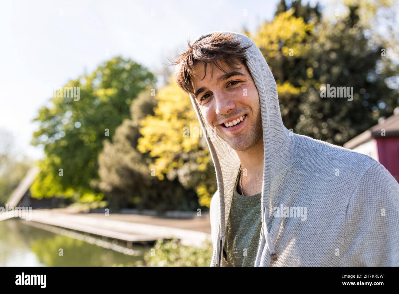 Young man with hooded shirt at park Stock Photo