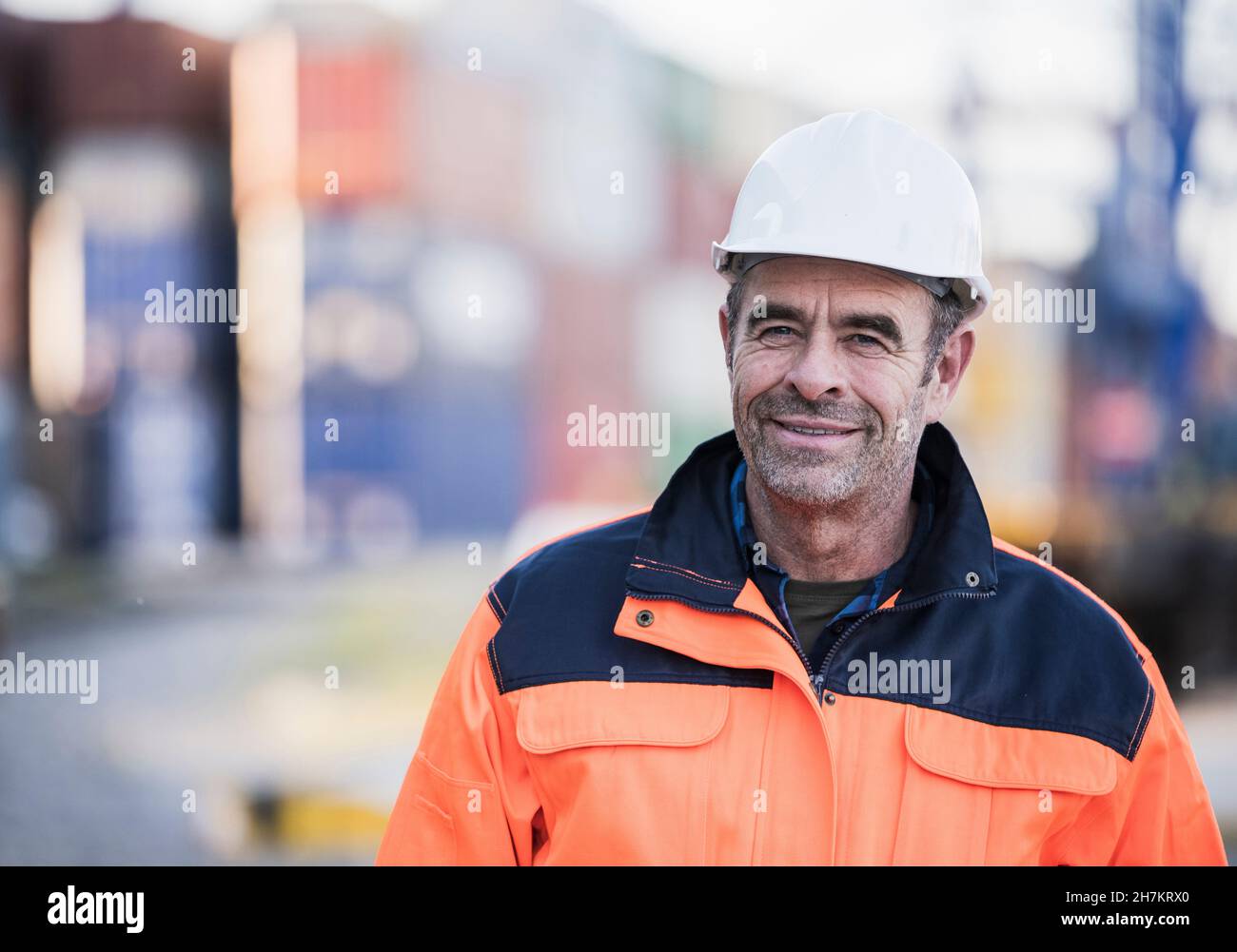 Smiling male blue-collar worker at industry Stock Photo
