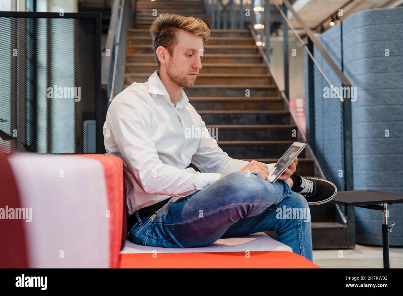 Young businessman using tablet PC at workplace Stock Photo