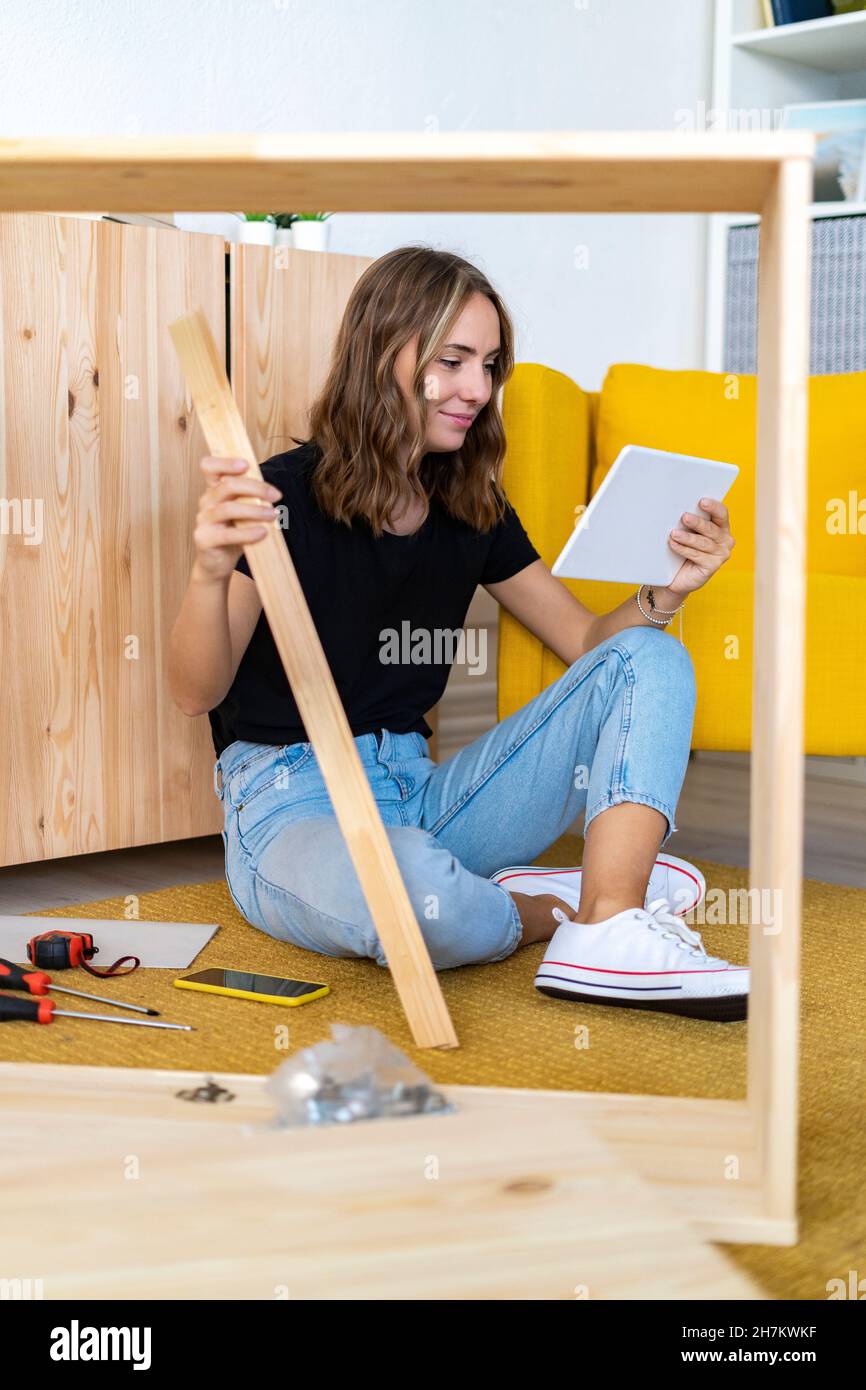 Young woman using digital tablet at home Stock Photo