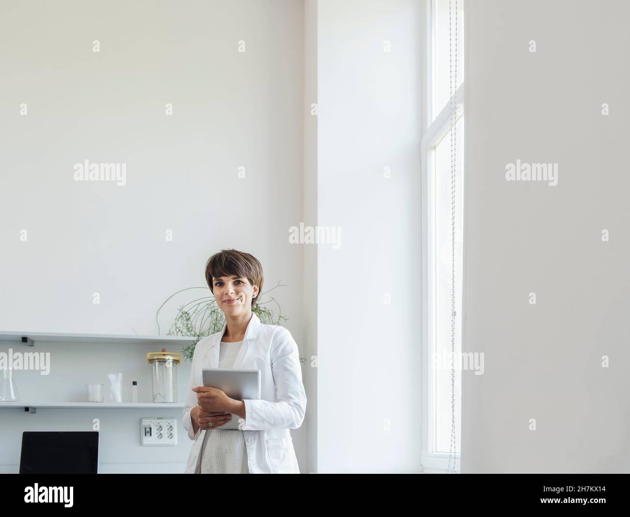 Smiling scientist with tablet PC at laboratory Stock Photo