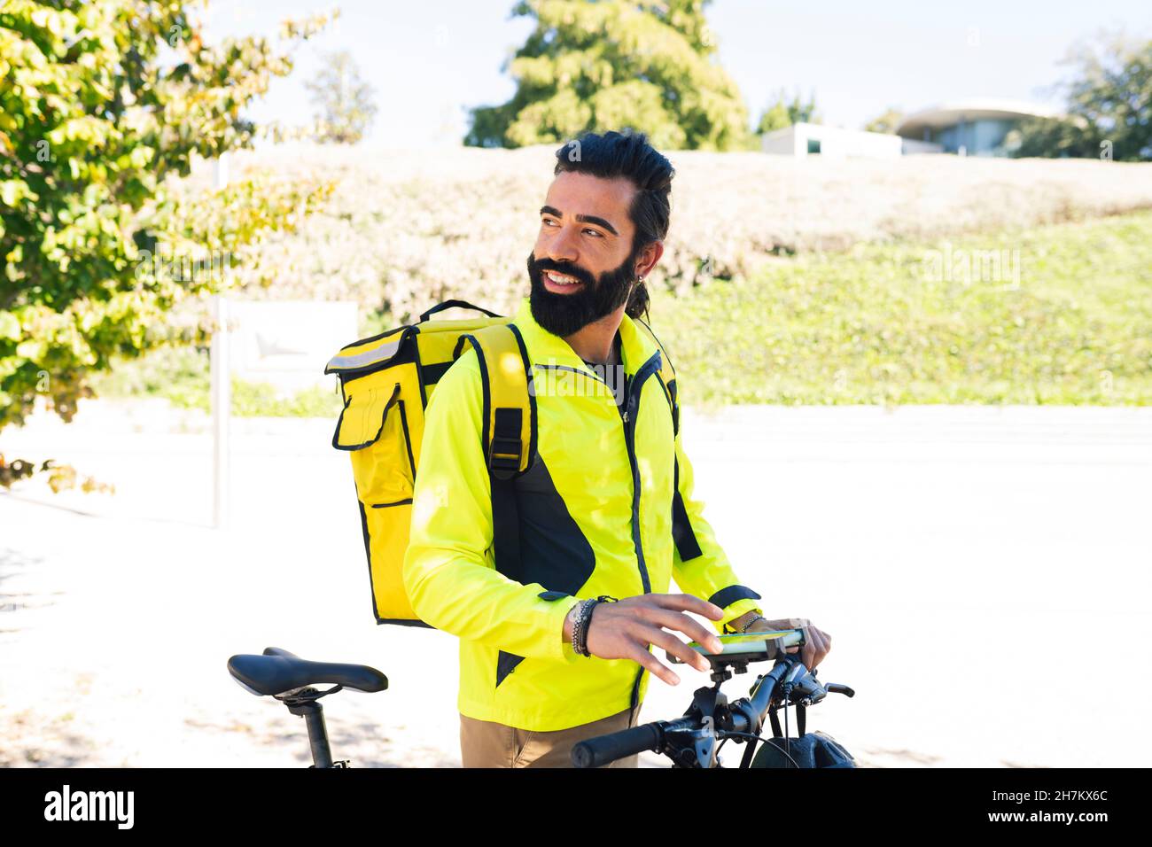 Delivery man using city map on mobile phone Stock Photo