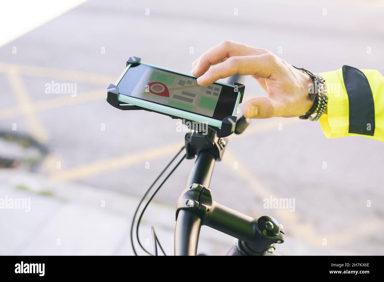 Delivery man with backpack using mobile phone by plants Stock Photo