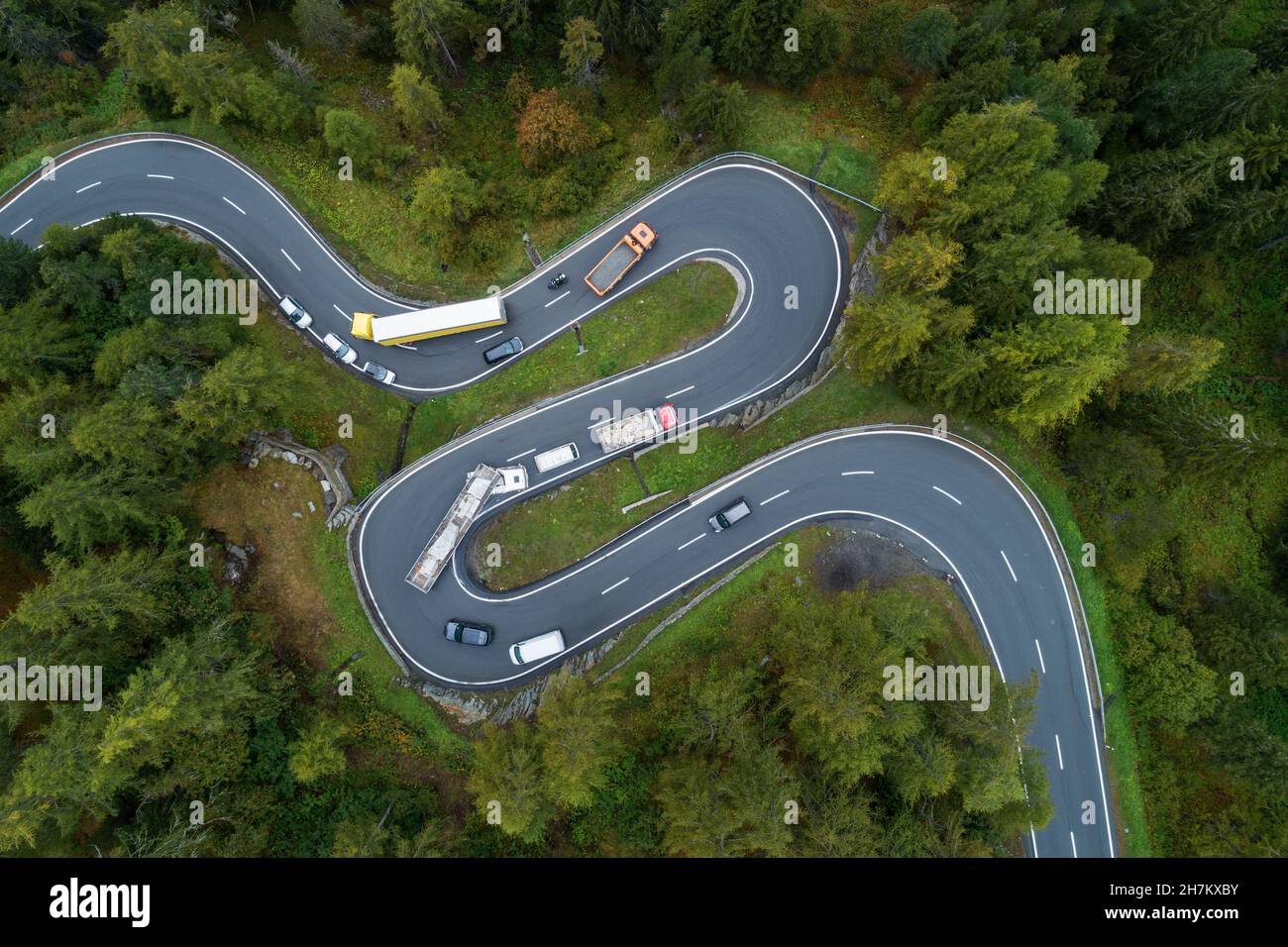 Drone view of cars driving along winding Maloja Pass road Stock Photo