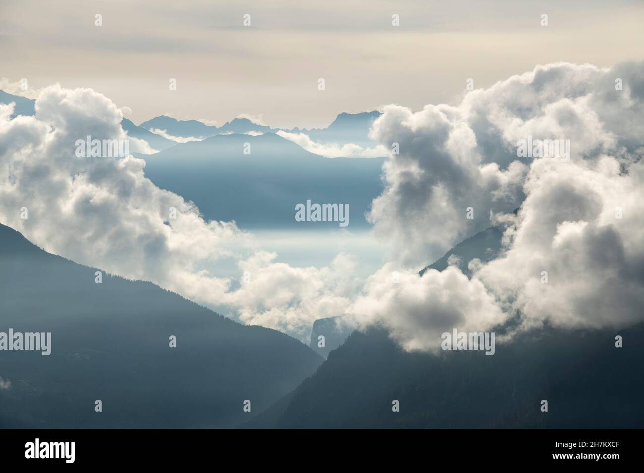 Low clouds floating over Gotthard Pass at dusk Stock Photo