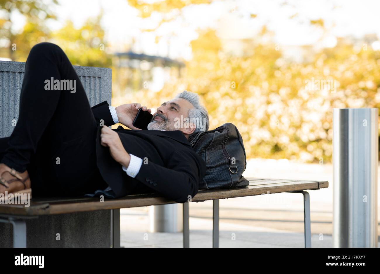 Businessman taking selfie through mobile phone Stock Photo