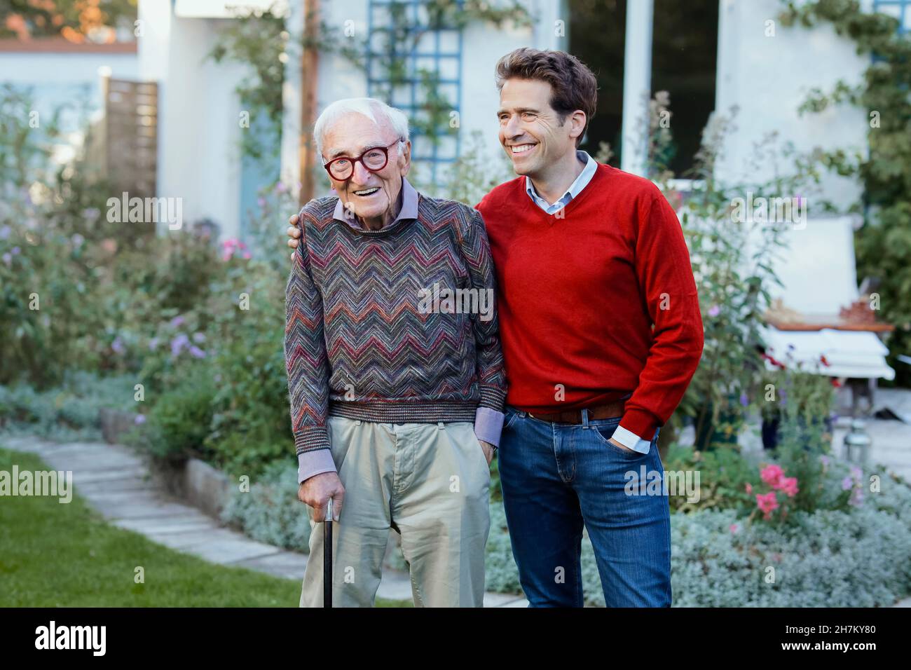Happy man with father in backyard Stock Photo
