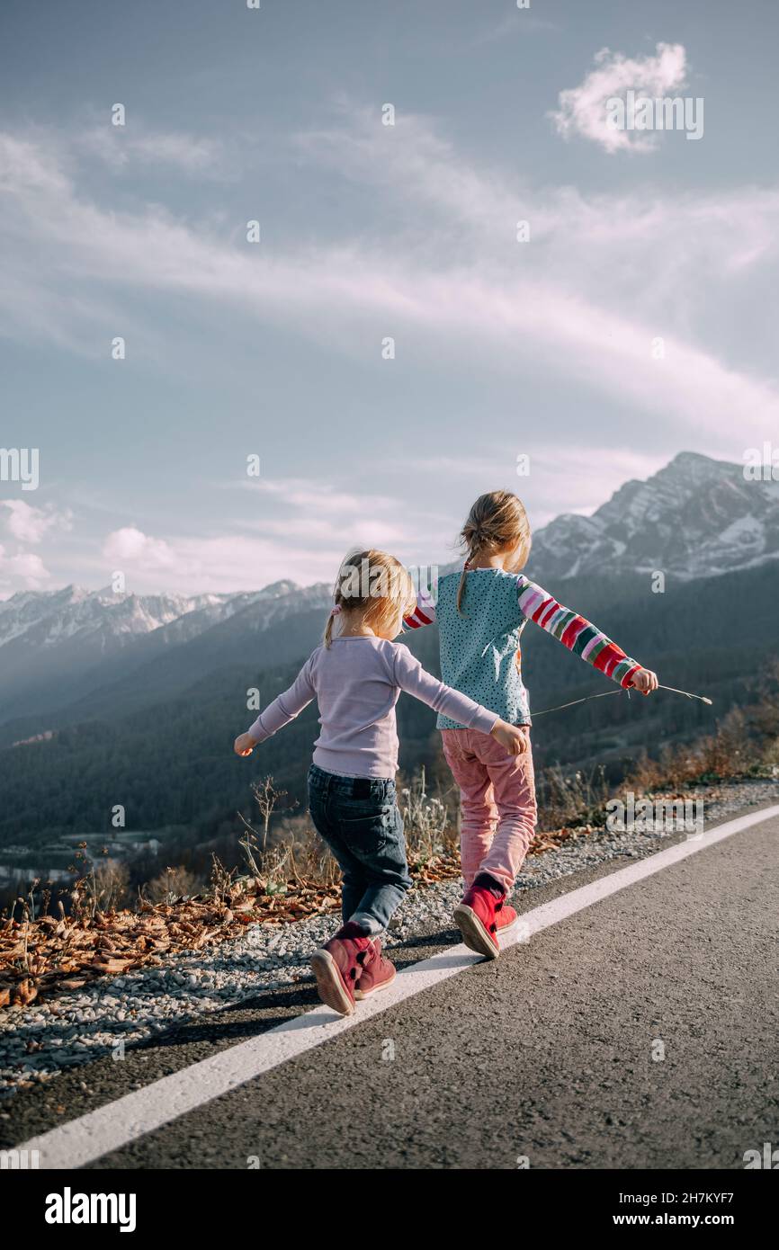 Two girls walking rear view hi-res stock photography and images - Alamy