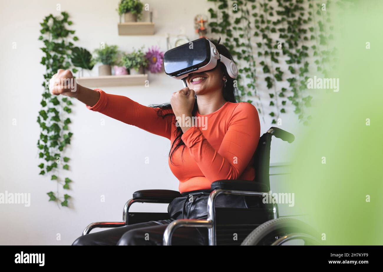 Smiling young woman with disability talking on smart phone Stock Photo