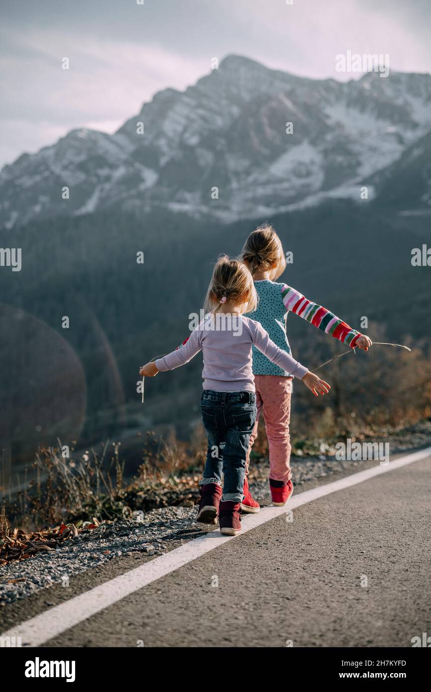 Rear view two girls walking hi-res stock photography and images - Alamy