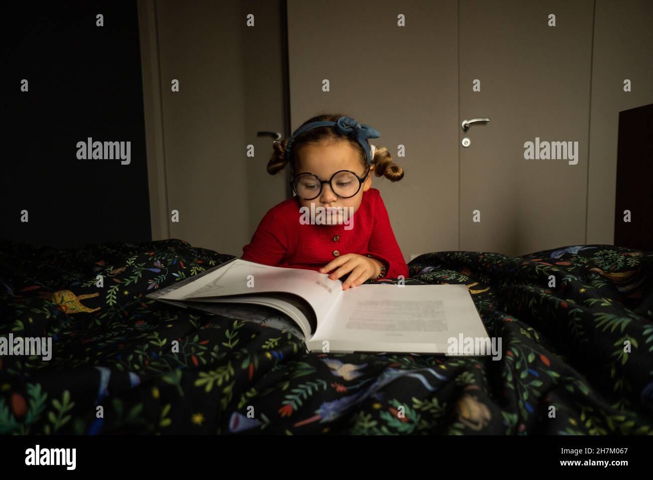 Cute Girl Reading Book In Bedroom Stock Photo Alamy