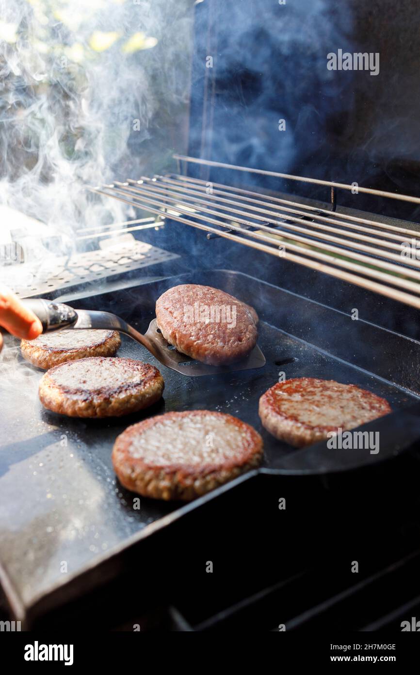 Meat with smoke on barbecue grill at backyard Stock Photo - Alamy