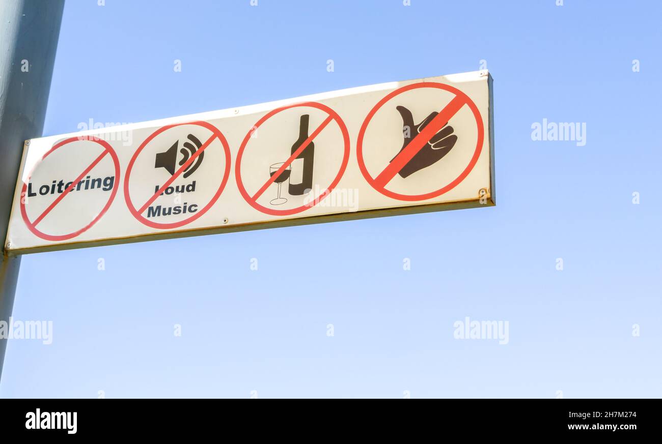 Banned activity sign showing activities not allowed against blue sky. Stock Photo