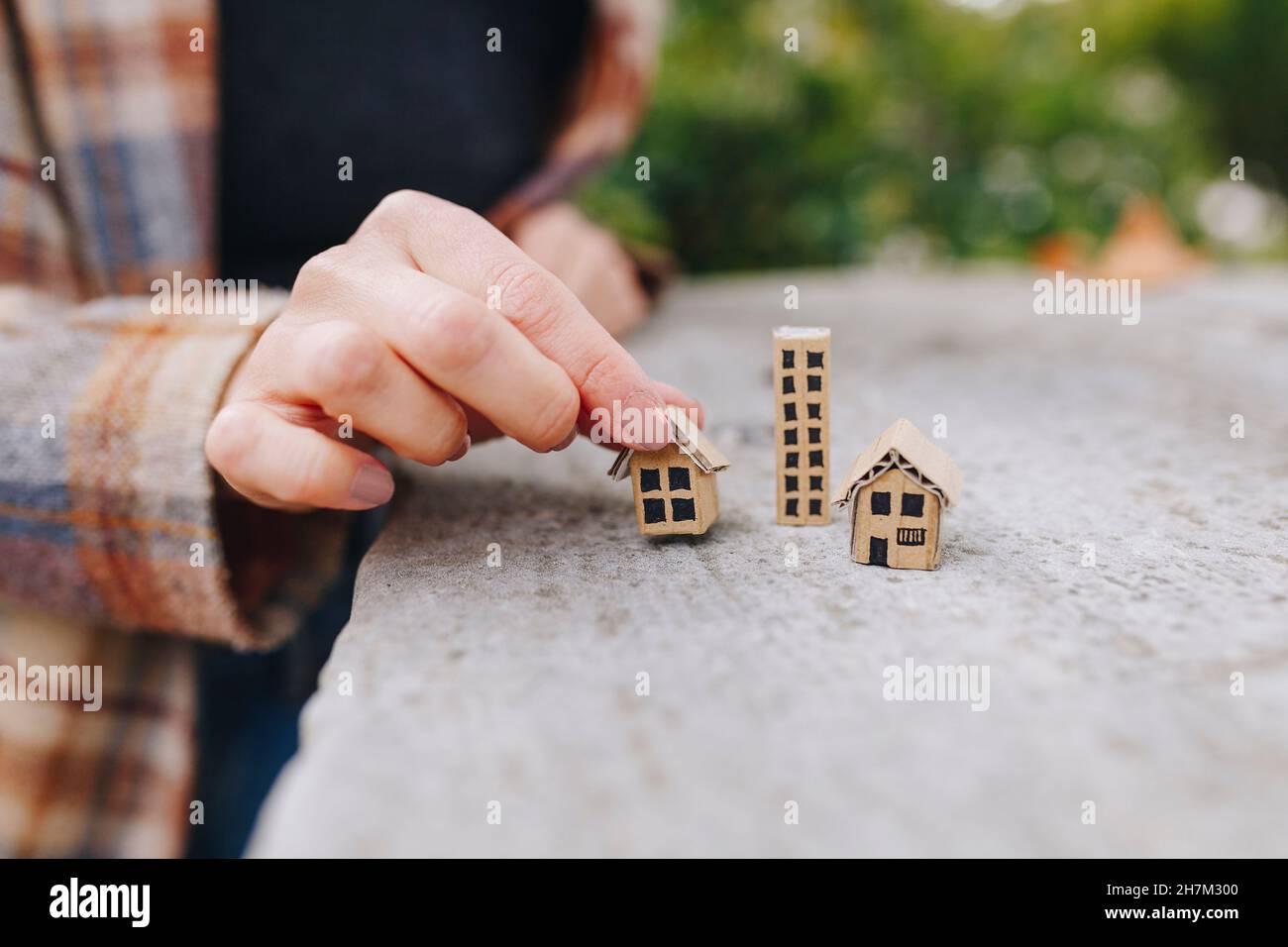 Real estate agent holding small model house on wall Stock Photo - Alamy