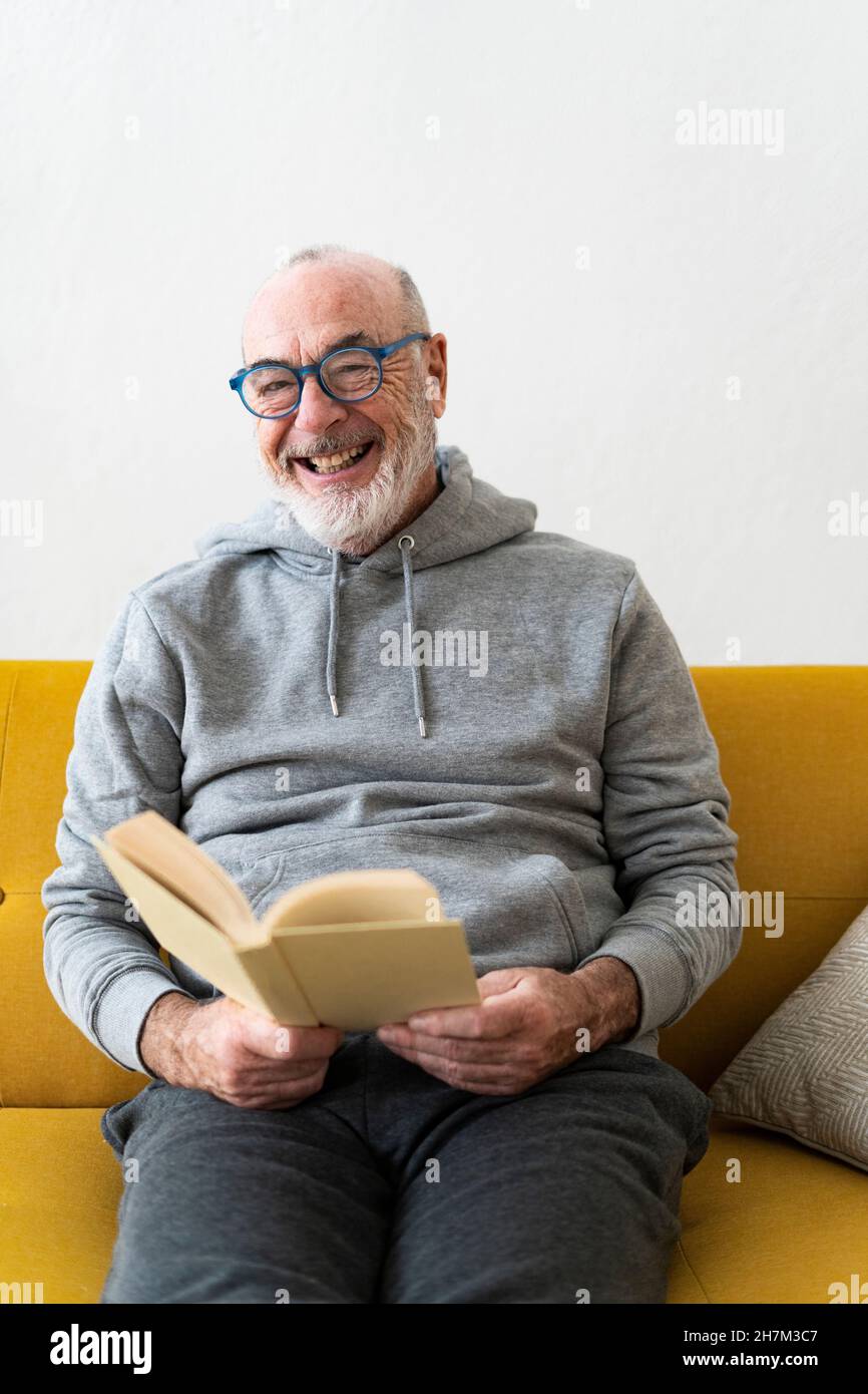 Happy senior man sitting sofa hi-res stock photography and images - Alamy