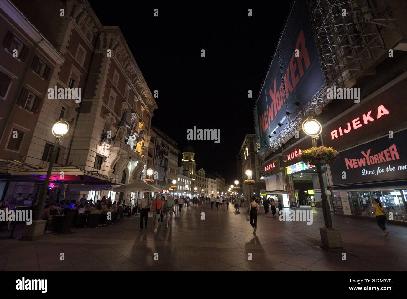 Picture of Rijeka at night with crowds passing by the street of Korzo, the main pedestrain way of Rijeka, croatia. Stock Photo