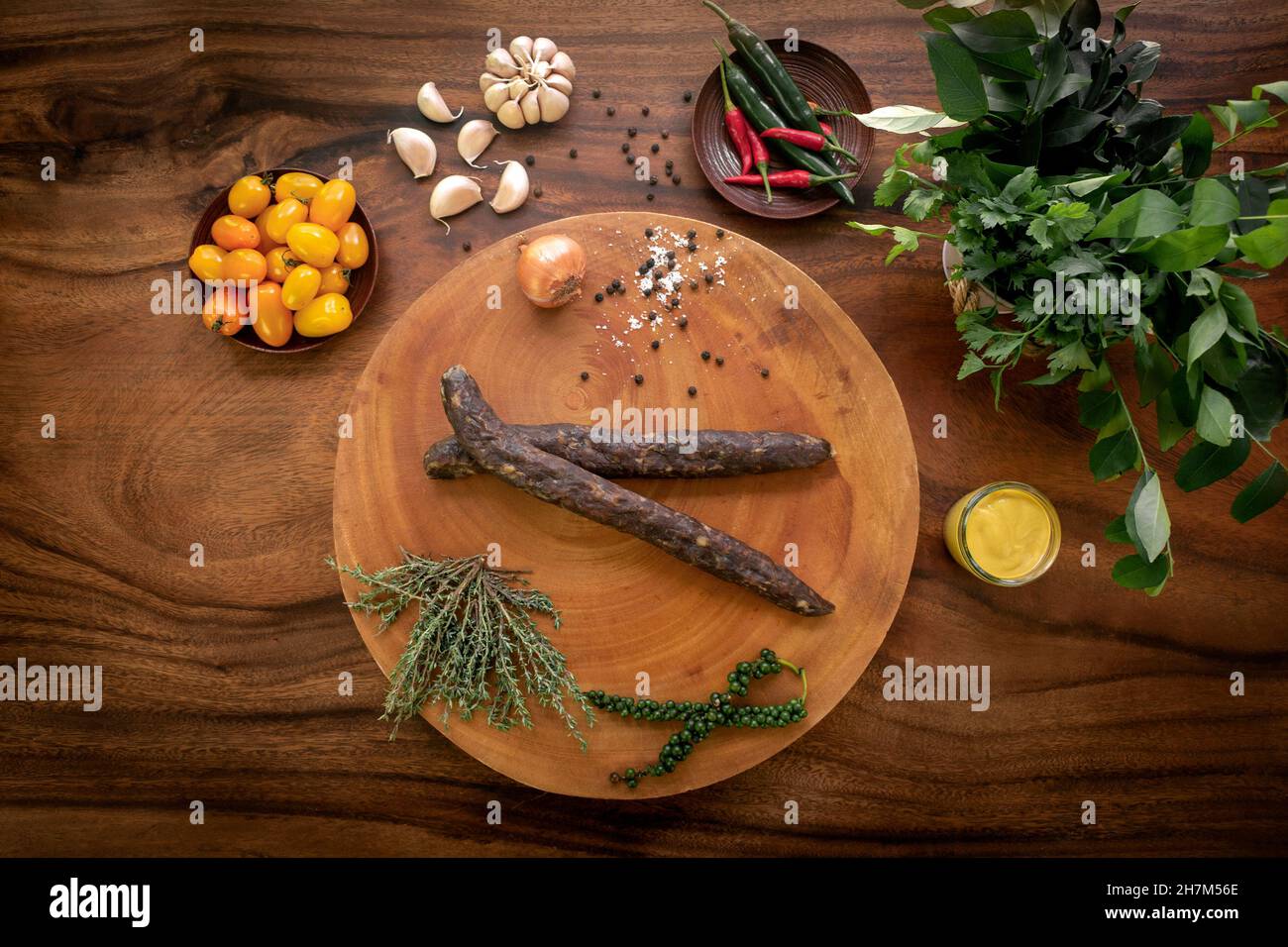 turkish sujuk spicy lamb sausages on rustic wood table with natural ingredients arrangement Stock Photo