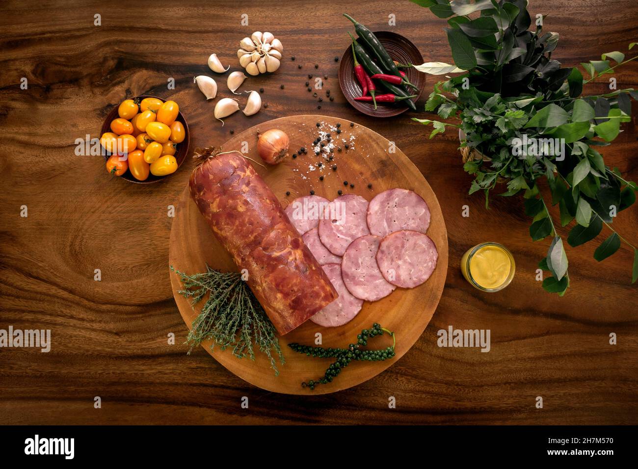 garlic ham sausage on rustic wood table with natural ingredients arrangement Stock Photo