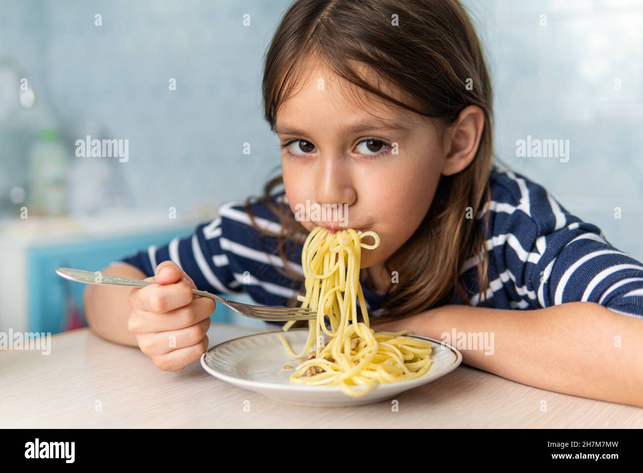 Kids eat pasta. Healthy lunch for children. Toddler kid eating
